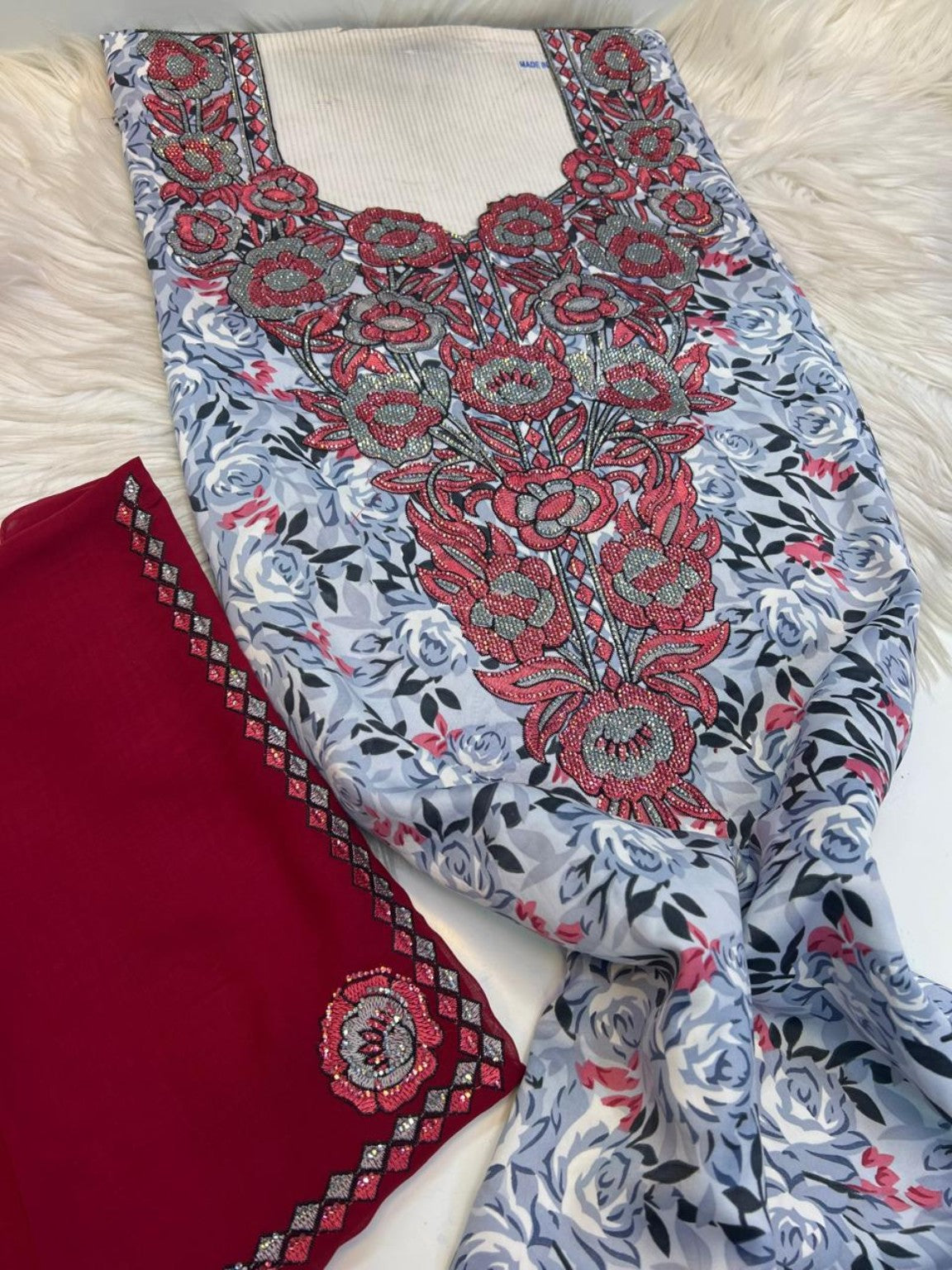 Grey rose print mukhawar fabric with red and silver embroidered neckline and deep red shayla